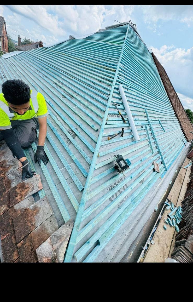 T&J Roofing team at work fitting battens during a re-roof