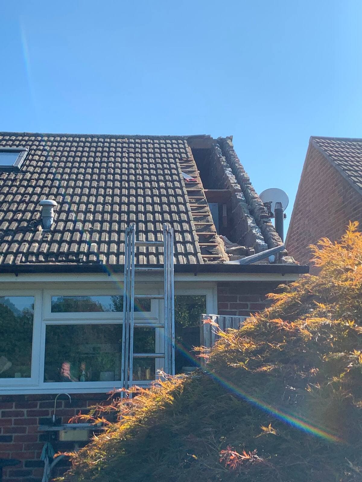 Roof with missing and damaged tiles after storm damage, before repair, near Guildford