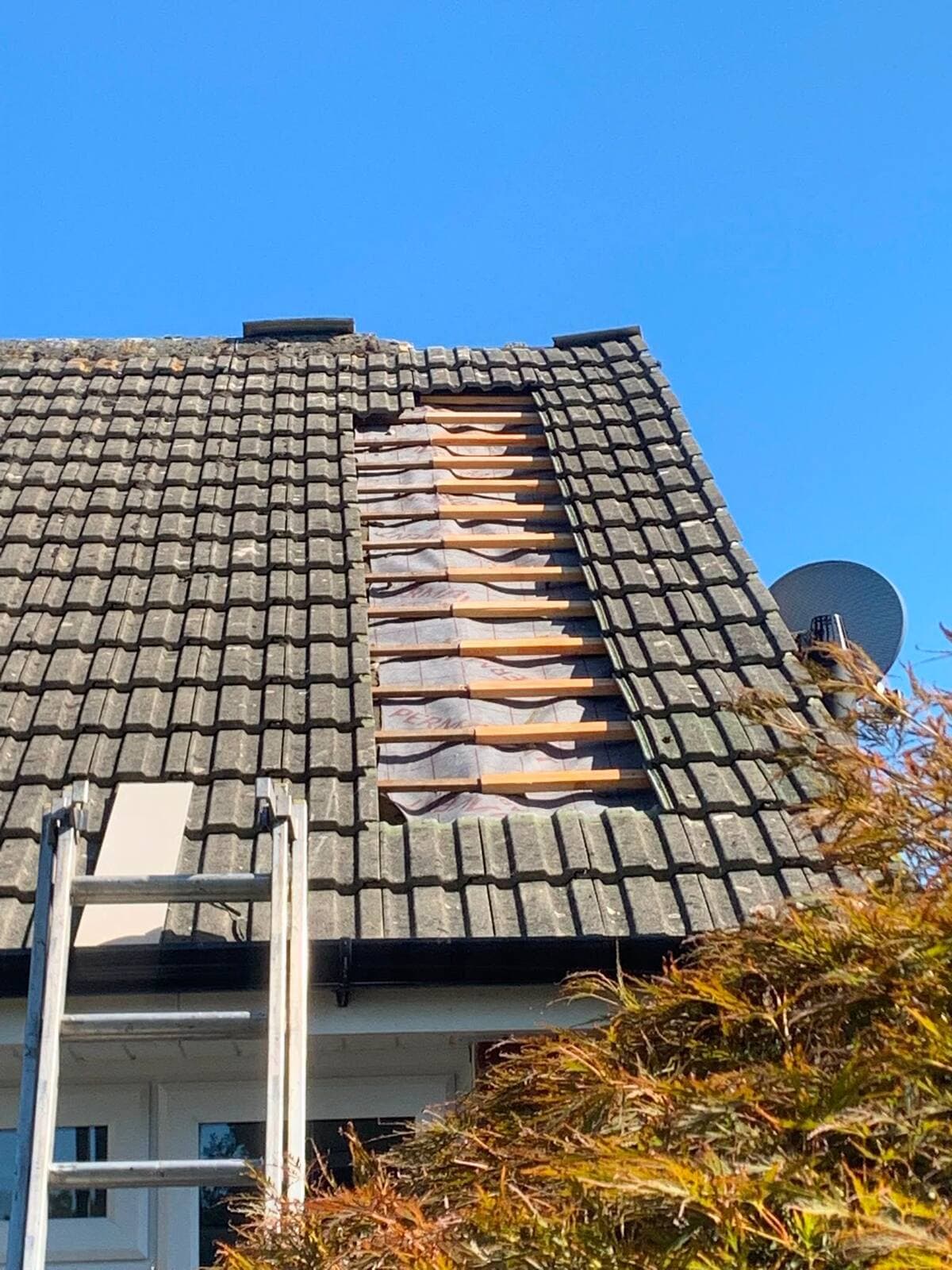 Roof tile repair in progress on a Surrey home