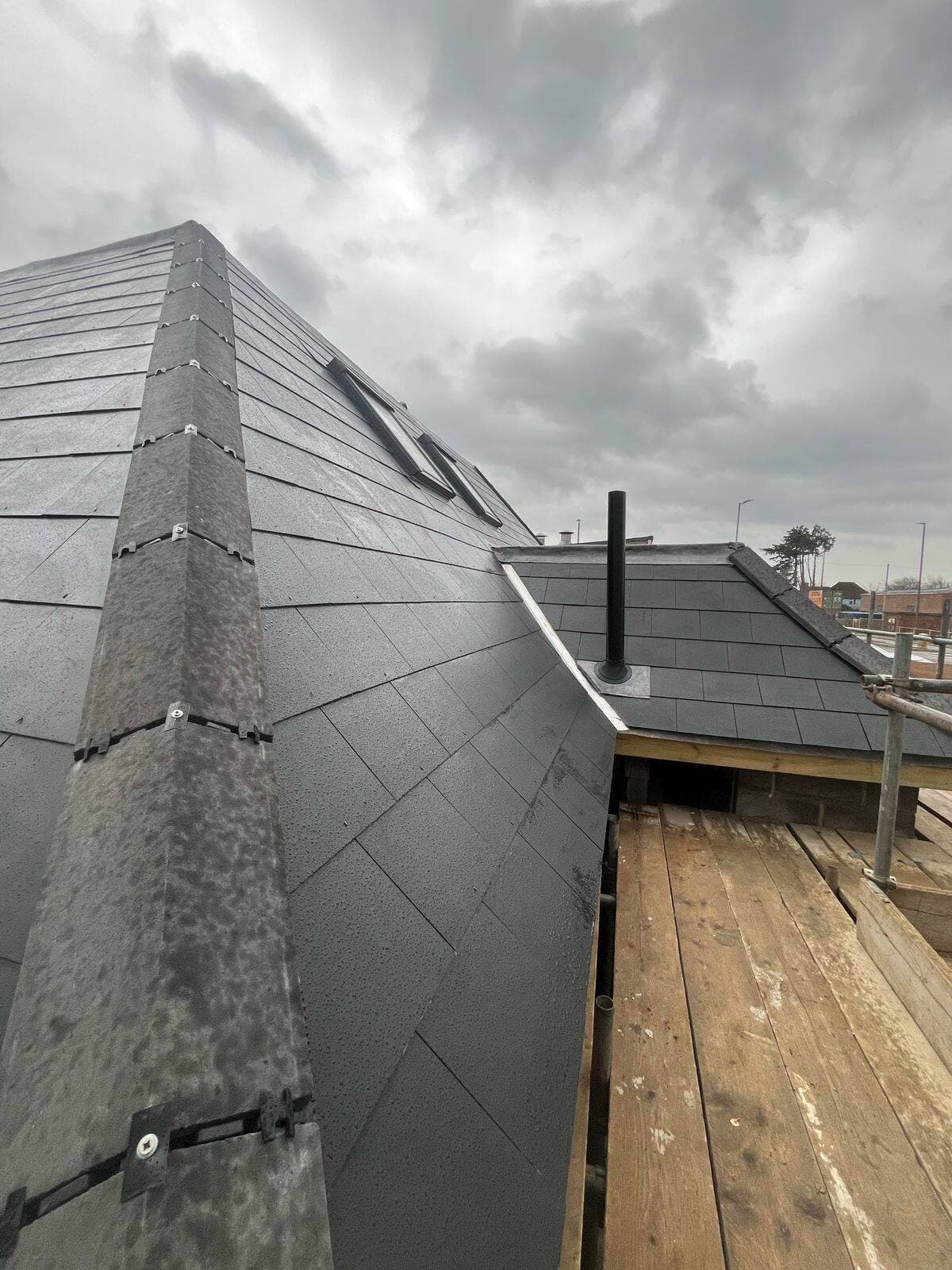 New slate roof with lead hip detailing, completed in Surrey