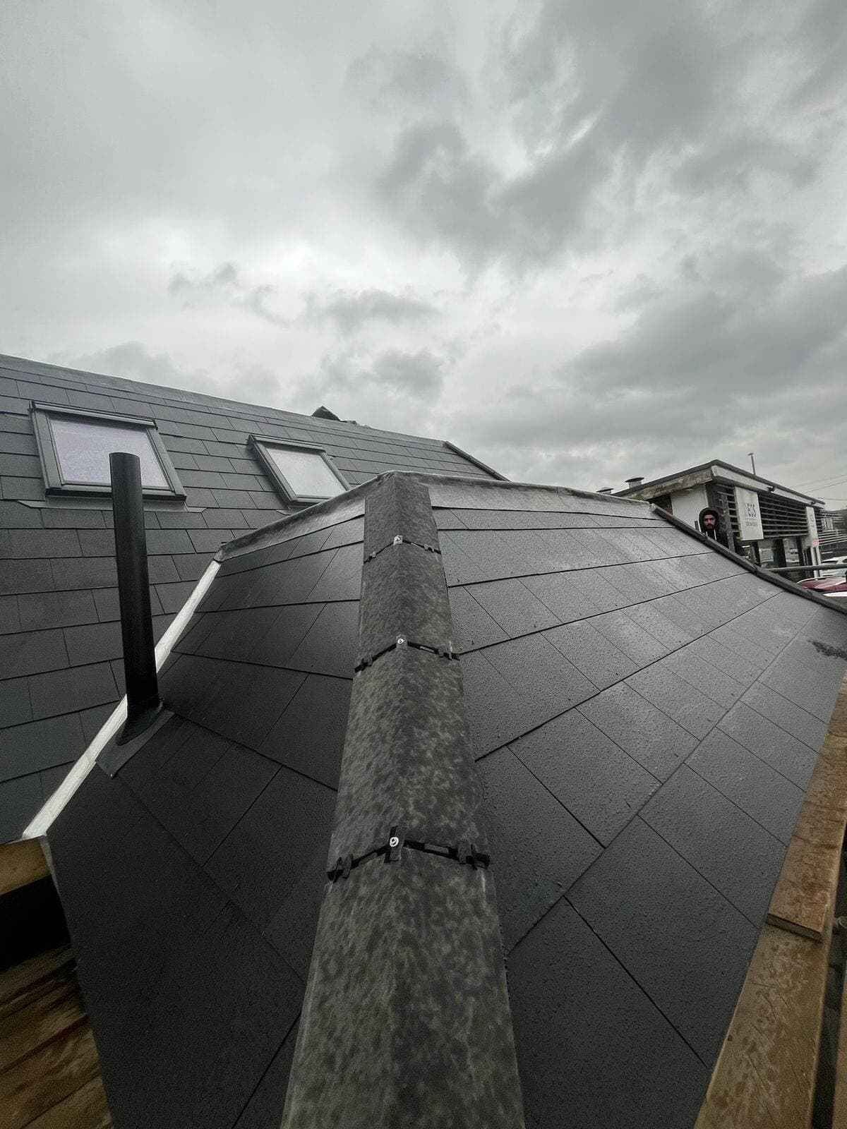 Completed slate roof with Velux rooflights, finished by T&J Roofing & Gutters near Guildford