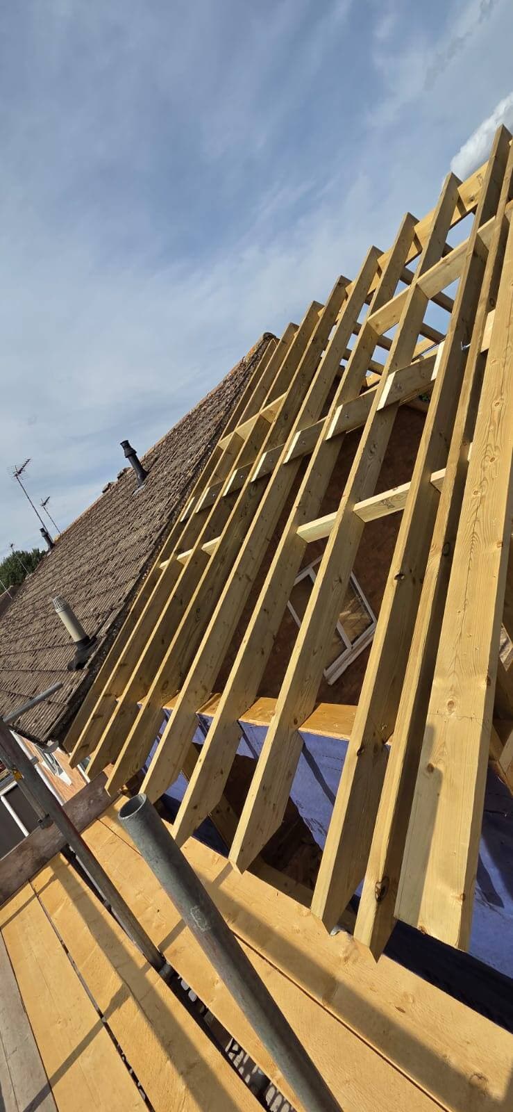 Roof structure and timber rafters exposed during a structural repair, Surrey